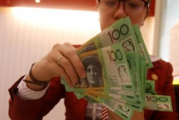 Dollar stabilizes amid hawkish Fed comments; Australian dollar struggles post rate hike