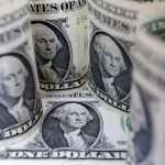 Dollar tracks global yields lower as Fed minutes awaited