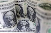 Dollar tracks global yields lower as Fed minutes awaited