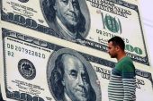 Dollar stabilizes near recent highs; sterling gains on strong PMI data