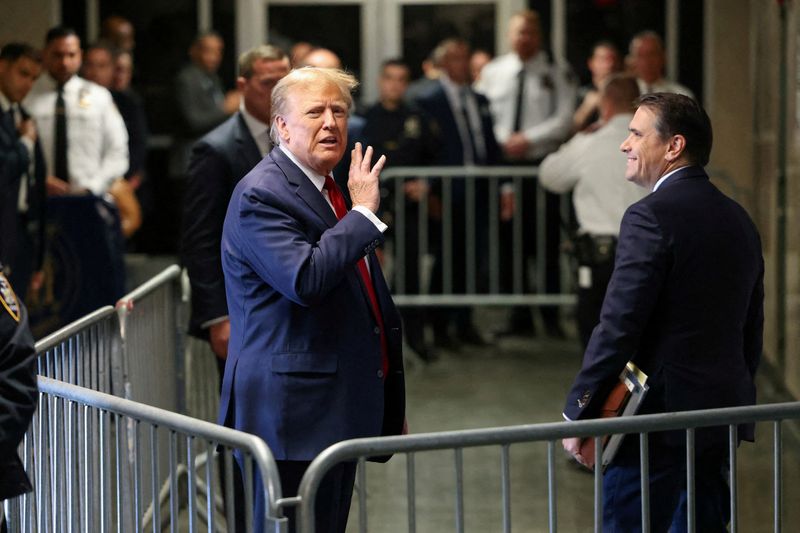 © Reuters. FILE PHOTO: Former U.S. President Donald Trump gestures outside the courtroom on the day of a court hearing on charges of falsifying business records to cover up a hush money payment to a porn star before the 2016 election, in New York State Supreme Court in the Manhattan borough of New York City, U.S., February 15, 2024. REUTERS/Andrew Kelly/File Photo