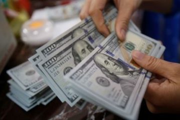 Dollar slips ahead of GDP data; euro rises and yen surges