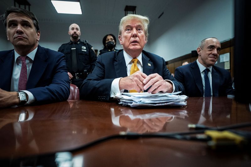 © Reuters. Former U.S. President Donald Trump, flanked by attorneys Todd Blanche and Emil Bove, arrives for his criminal trial at the Manhattan Criminal Court in New York, NY on Wednesday, May 29, 2024. Trump was charged with 34 counts of falsifying business records last year, which prosecutors say was an effort to hide a potential sex scandal, both before and after the 2016 presidential election. Trump is the first former U.S. president to face trial on criminal charges.  Jabin Botsford/Pool via REUTERS