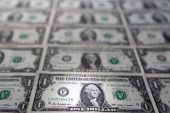 Dollar pares losses as Fed officials project only one rate cut this year