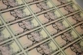 Dollar stabilizes after sharp rebound; Fed officials in focus