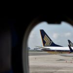 Singapore Airlines' half-year profit nearly halves on rising costs