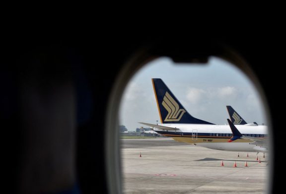 Singapore Airlines' half-year profit nearly halves on rising costs