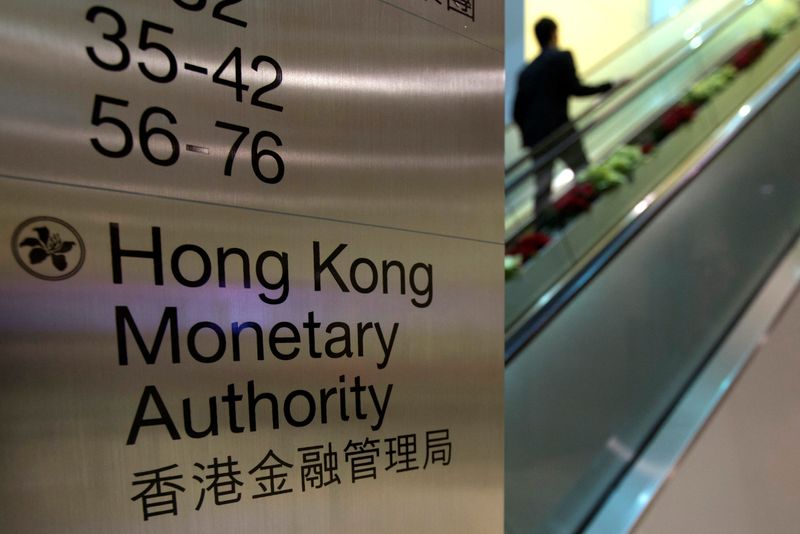 © Reuters. FILE PHOTO: A security guard walks past a directory board of Hong Kong Monetary Authority (HKMA) in Hong Kong December 20, 2012. REUTERS/Tyrone Siu/File Photo